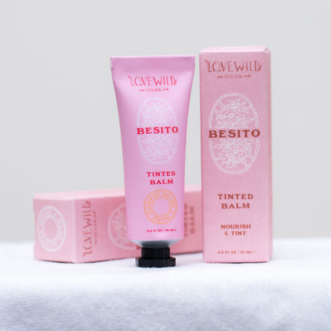 Pink 'Besito' tinted balm with packaging on a white background