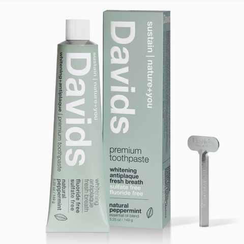David's premium toothpaste with packaging and a dental tool on a white background