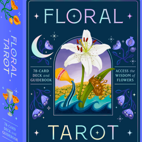 Floral Tarot card set packaging with a white lily illustration on a dark blue background.