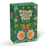 The 'Flower Child Tarot' deck box by Kira Cyan, featuring a dark green background decorated with colorful flowers, a butterfly, and flower faces, shown on a clean white background with a soft shadow.