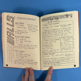 An open notebook showing handwritten woodworking and cleaning instructions, photographed against a bright blue background. A hand is visible holding the notebook open.