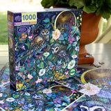Jigsaw puzzle box with a colorful owl and nature design, surrounded by partially completed puzzle pieces.