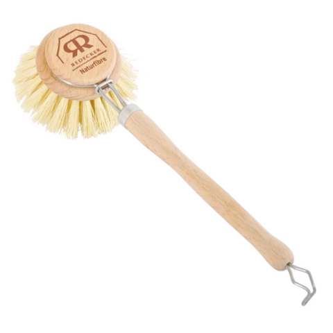 A wooden-handled dish brush with cream-colored bristles and a metal hook at the end, shown on a white background. The round wooden head is branded with the R.