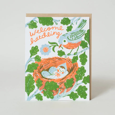 Greeting card with a bird, nest, and baby illustration on a light background