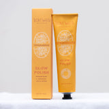 Orange tube and box of Lovewild Glow Polish on a white background.