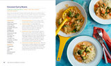 A printed cookbook spread showing a prepared coconut curry bowl in a blue bowl with rice, peas, and cucumber, alongside recipe text and ingredient lists for 'Coconut Curry Bowls' on pages 102 and 103.