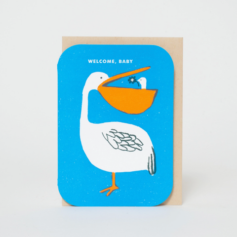 Greeting card with a pelican illustration and 'Welcome, Baby' text on a blue background.