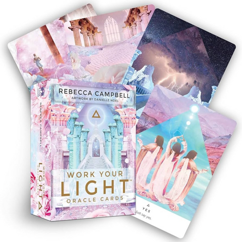 The 'Work Your Light Oracle Cards' deck by Rebecca Campbell, featuring a pastel pink and blue illustrated box alongside several fanned-out oracle cards displaying cosmic, architectural, and spiritual illustrations.