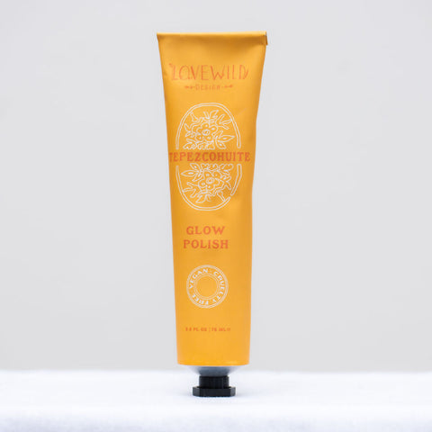 Orange tube of 'Glow Polish' exfoliant on a white background